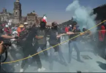 Protesters manage to tear down the welded metal fences of the National Palace