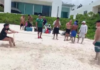 Foreign woman attempts to claim ownership of a beach in Playa del Carmen; Mexicans organize a picnic in front of her house in protest.